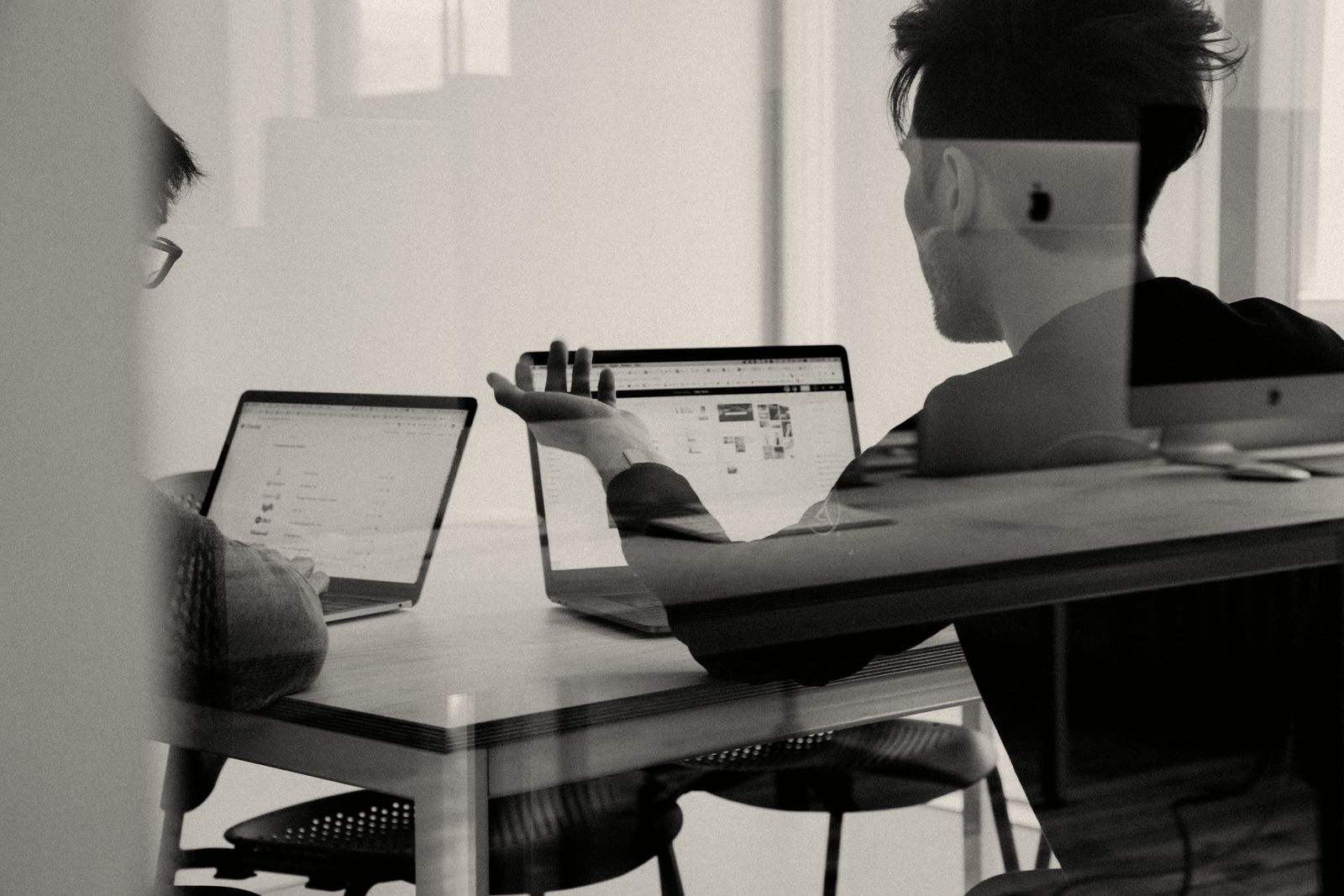 Talking through a network plan with a client at a laptop